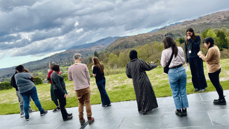 Students and staff of Diverse CDT standing outside and admiring the view of the Lake District