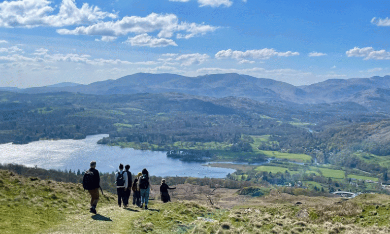 A small group of students and staff walking in the Lake District
